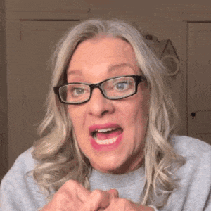 a woman wearing glasses is making a funny face and making a funny face .