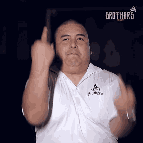a man wearing a white shirt that says brother 's giving the middle finger