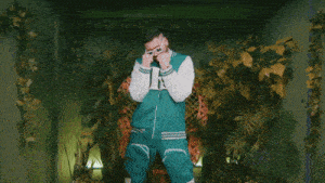 a man wearing a blue jacket with the letter k on the front