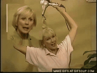 a woman is blow drying her hair in front of a mirror with the words make gifs at gifsoup.com below her
