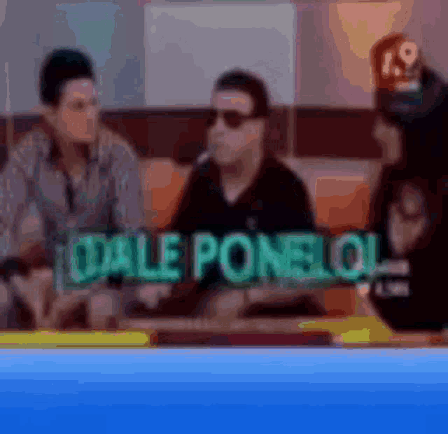 a blurry picture of a man sitting at a table with the words dale ponelo written on it
