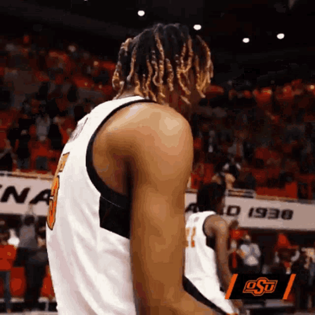 a basketball player wearing a number 11 jersey stands on a court