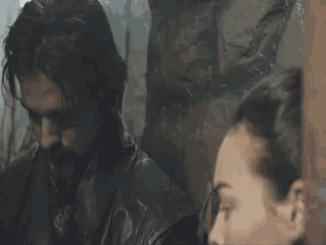 a man and a woman are standing next to each other .