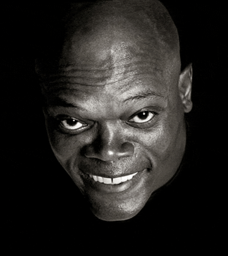 a black and white photo of a man smiling