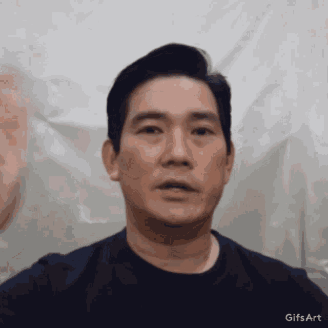 a man 's face is shown in a gif with the words gifs art at the top