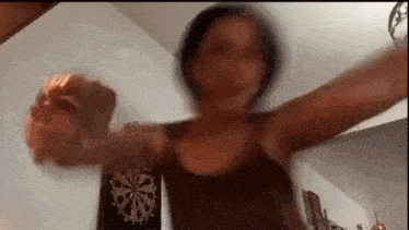 a woman is standing in front of a dart board .