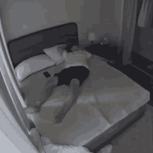 a person is laying on a bed in a room with korean writing on it