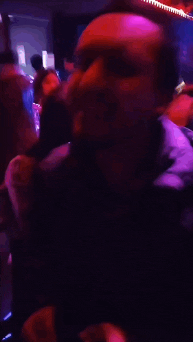 a blurry photo of a man dancing in a dark room