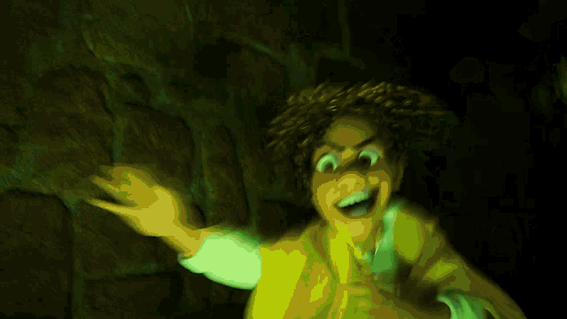 a cartoon character with green eyes and a green cape .