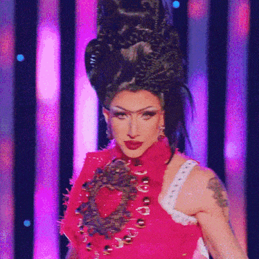 a woman with a tattoo on her arm is wearing a red dress