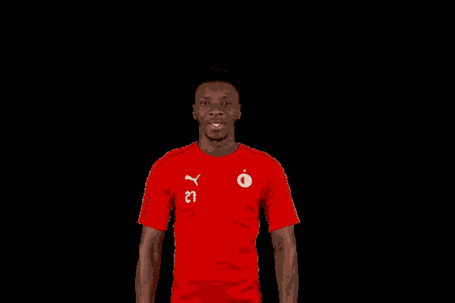 a man wearing a red shirt with the number 21 on the front
