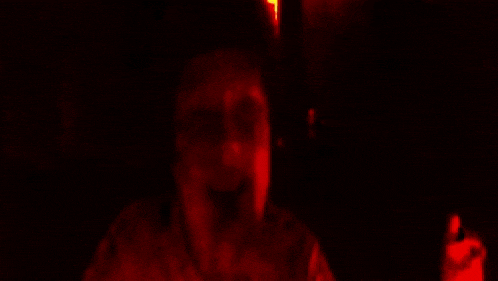 a blurry picture of a person 's face with a yellow background .