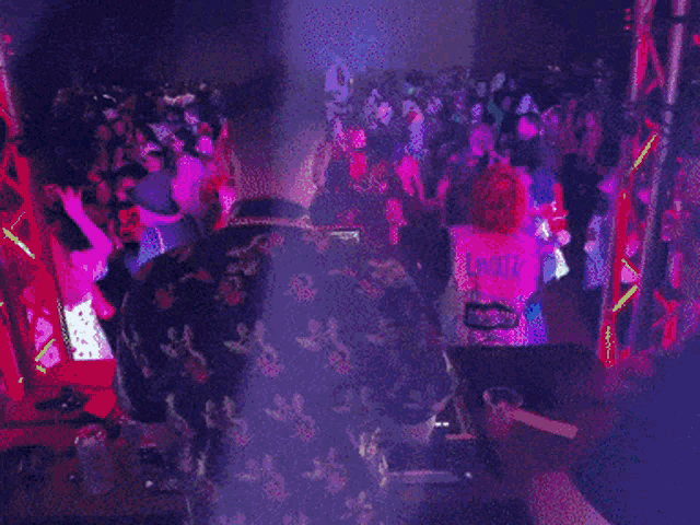 a crowd of people are dancing at a party with a sign that says ' funk ' on it