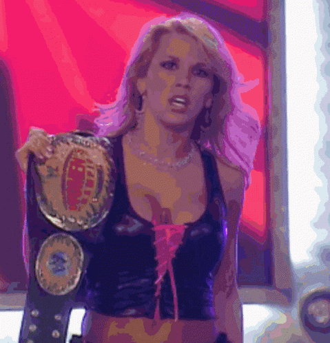 a woman in a black top is holding a championship belt that says ' intercontinental ' on it