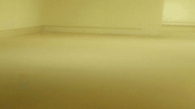 a dimly lit hallway with the words backrooms glowing in yellow