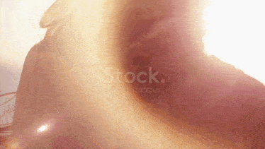 a close up of a person 's face with the sun shining through it