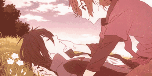 a couple of anime characters are laying in the grass and one of them is touching another 's face