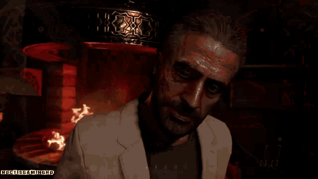 a man standing in front of a fireplace with the words nocturnamiyoko.ru written below him