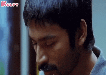a close up of a man 's face with a mustache eating food .
