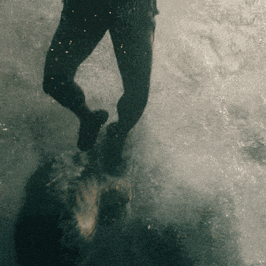 a person 's feet are visible in a blurry photo