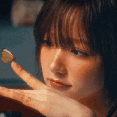 a woman with a butterfly on her finger