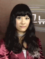 a woman with long black hair is wearing a red jacket