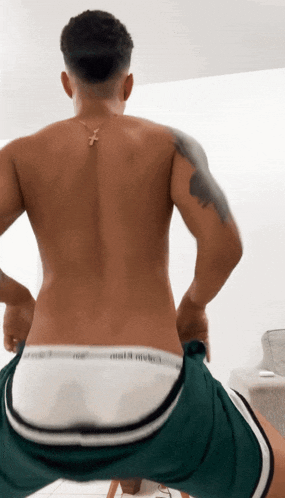 a man without a shirt is wearing calvin klein underwear