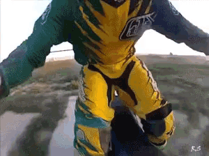 a person wearing a green and yellow outfit with the letters rs on the bottom