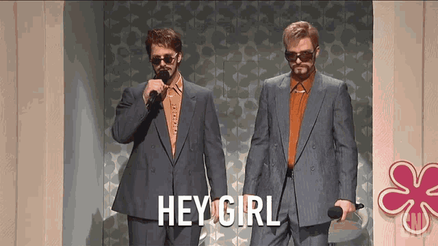 two men in suits are standing next to each other with the words hey girl written on the bottom