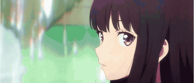 a close up of a girl with long black hair and purple eyes looking at the camera .