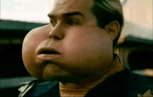 a close up of a man 's face with a large lump on it .