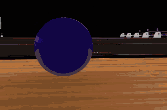 a purple bowling ball is on a wooden table