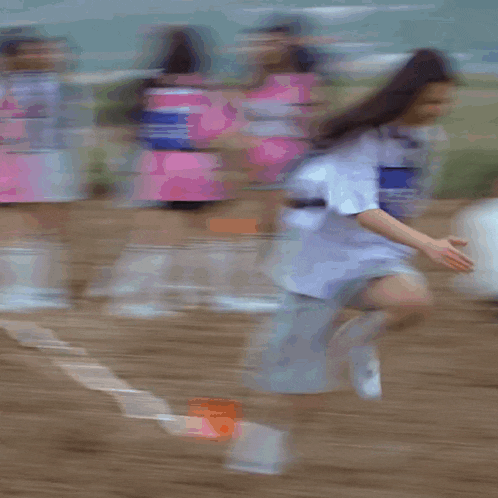 a person is laying on the ground in a field with a flag in the background