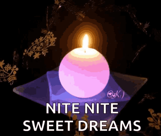 a candle is lit up in the dark with the words nite nite sweet dreams