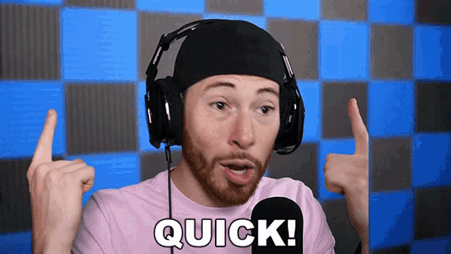 a man wearing headphones and a pink shirt with the words quick on it