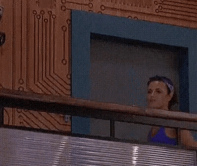a woman is standing in an elevator looking out the window .