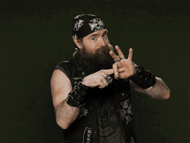 a man with a beard is wearing a bandana that says iron cross on it