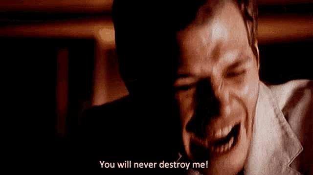a man in a suit says you will never destroy me