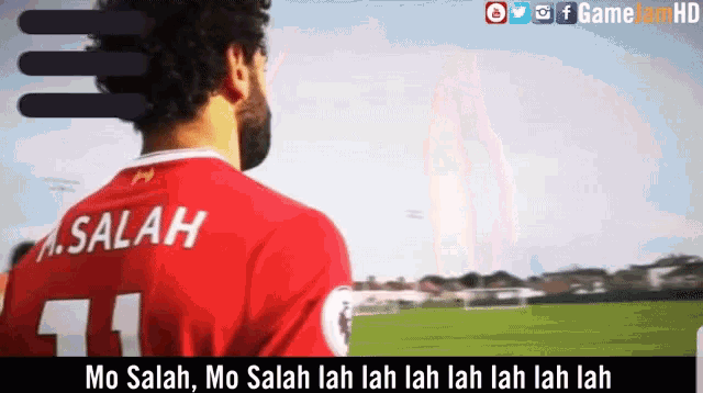 a man in a red soccer jersey with the name salah on it
