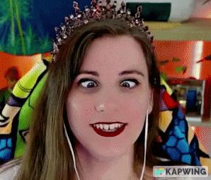 a woman wearing a tiara and earbuds is making a funny face