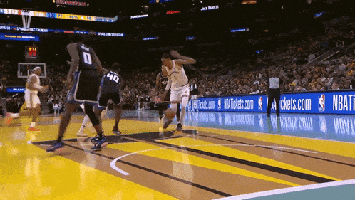 a basketball game is being played in front of a banner that says nbatickets.com