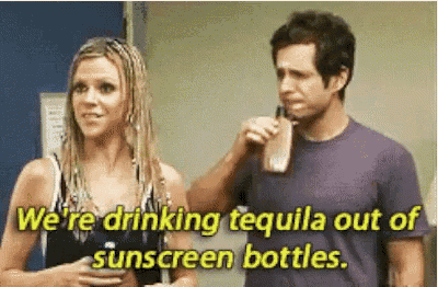 a man and a woman are drinking tequila out of sunscreen bottles while standing next to each other .
