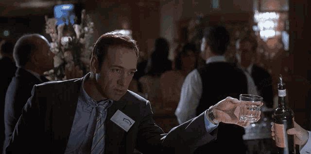 a man in a suit with a name tag that says ' g ' on it