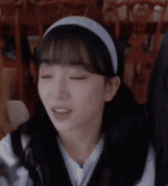 a close up of a girl wearing a headband .