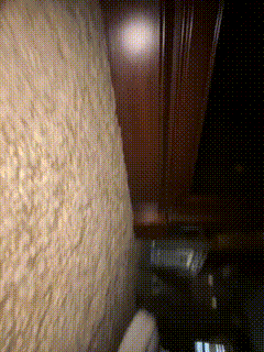 a blurred image of a wall with a few spots of light on it
