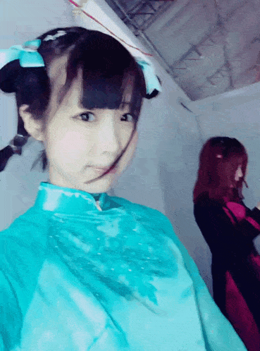 a girl in a blue dress with a blue bow in her hair