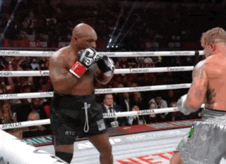 two boxers in a ring with one wearing shorts that say byu on them