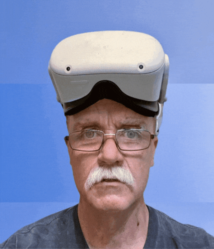 a man wearing glasses and an oculus headset