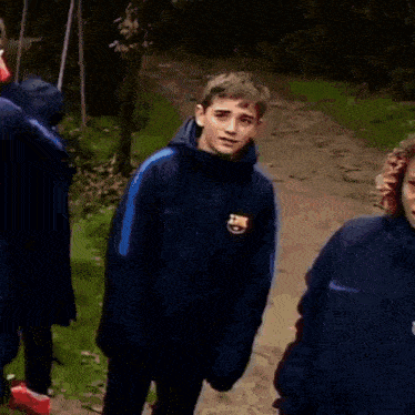 a group of men are walking down a hallway wearing lanyards that have the letter h on them