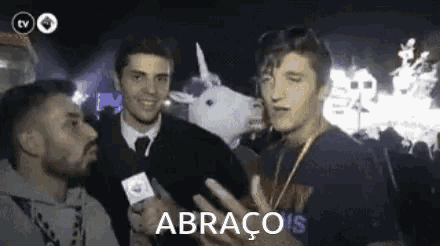 a man wearing a unicorn mask is being interviewed by a man with a microphone .